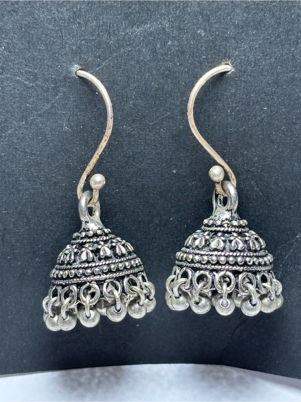 Jhumka earrings are traditional, bell-shaped drop earrings